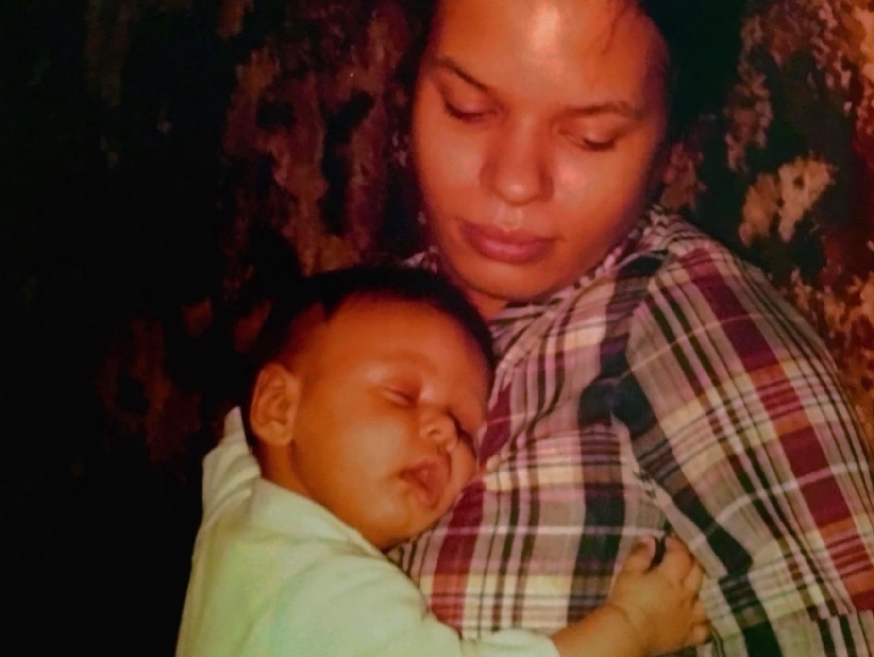 Joyce holding Khary as a baby, his head resting on her shoulder